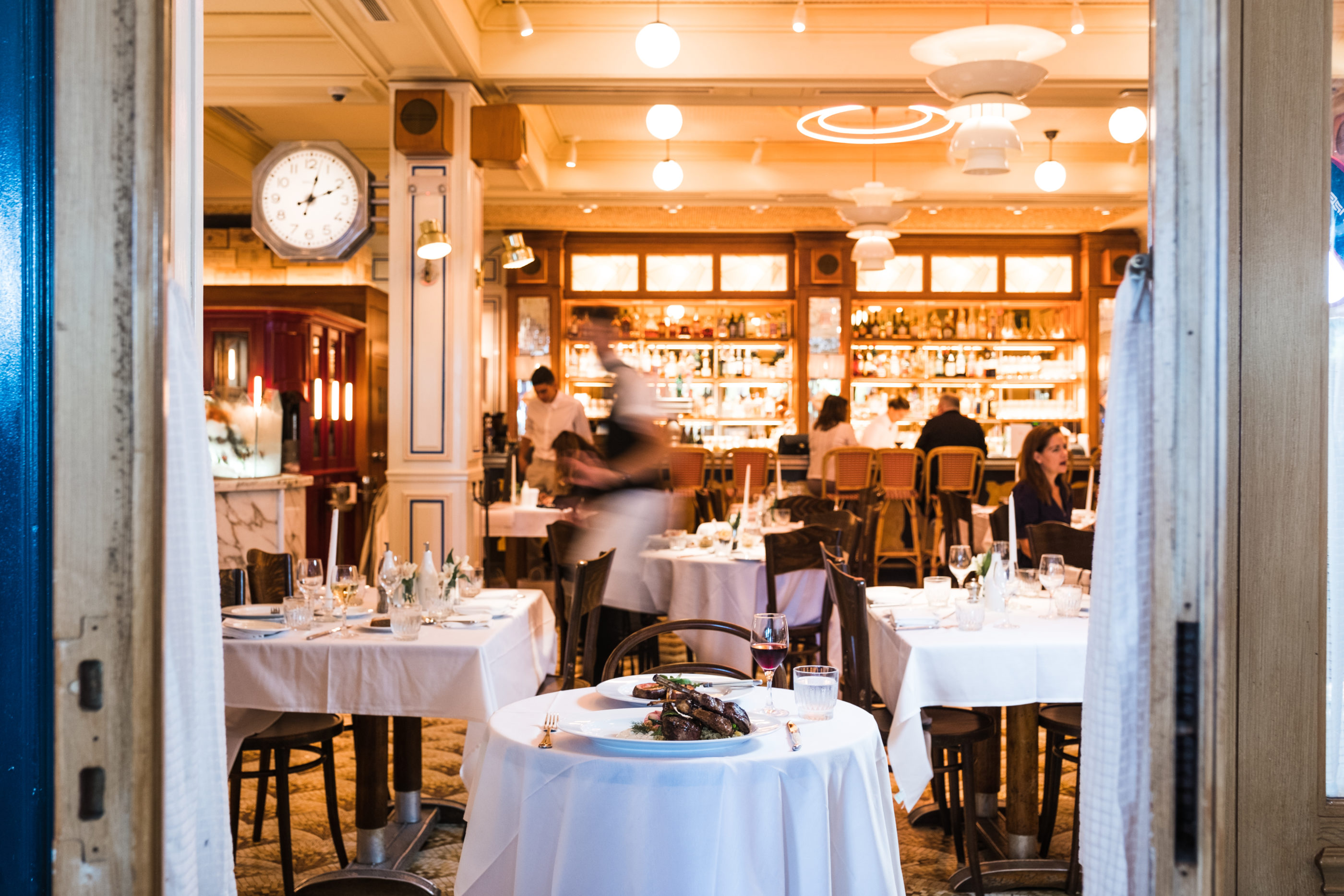 Busy dining room of server walking through